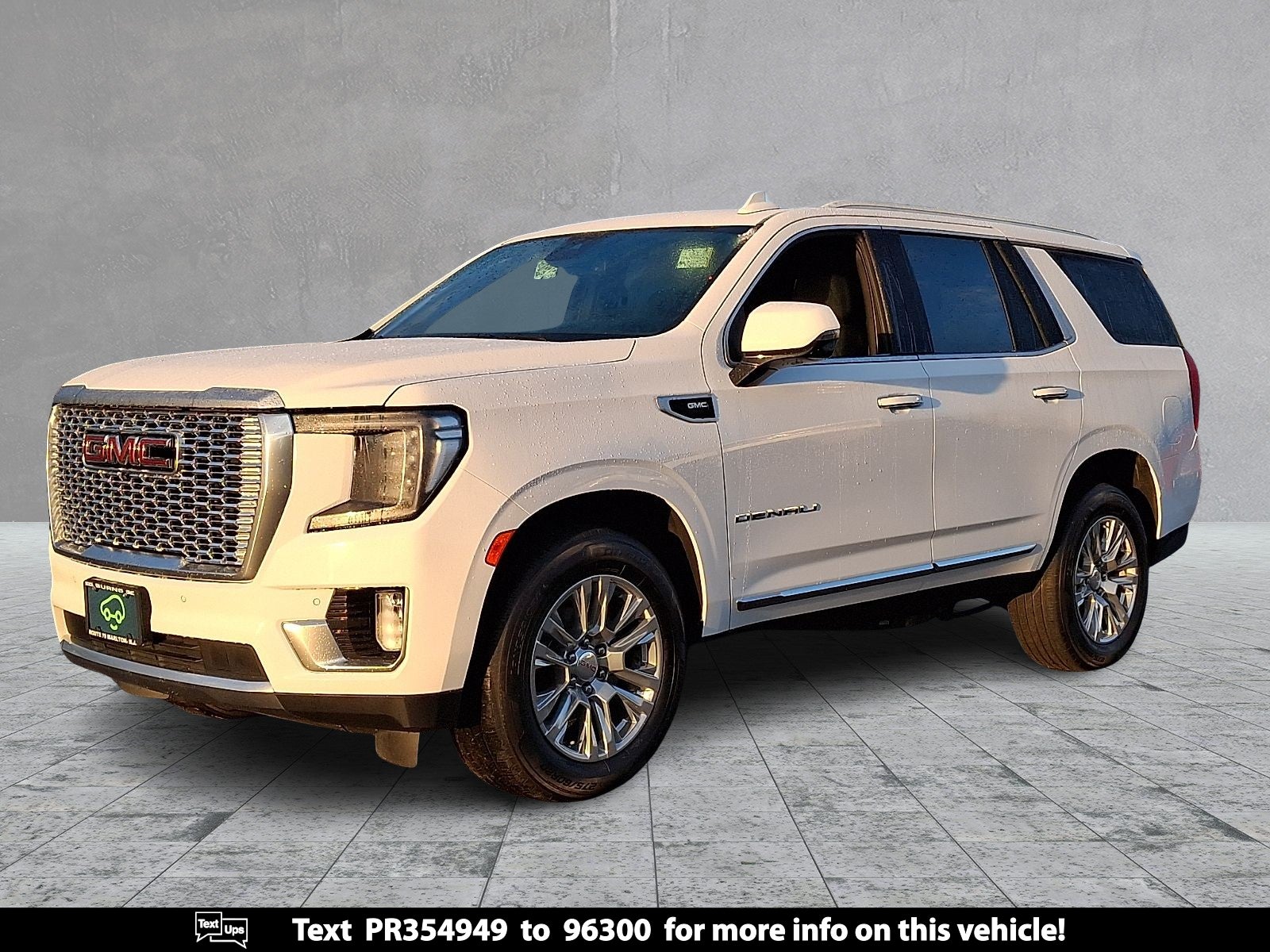 2023 GMC Yukon Denali in Summit White — front three-quarter view