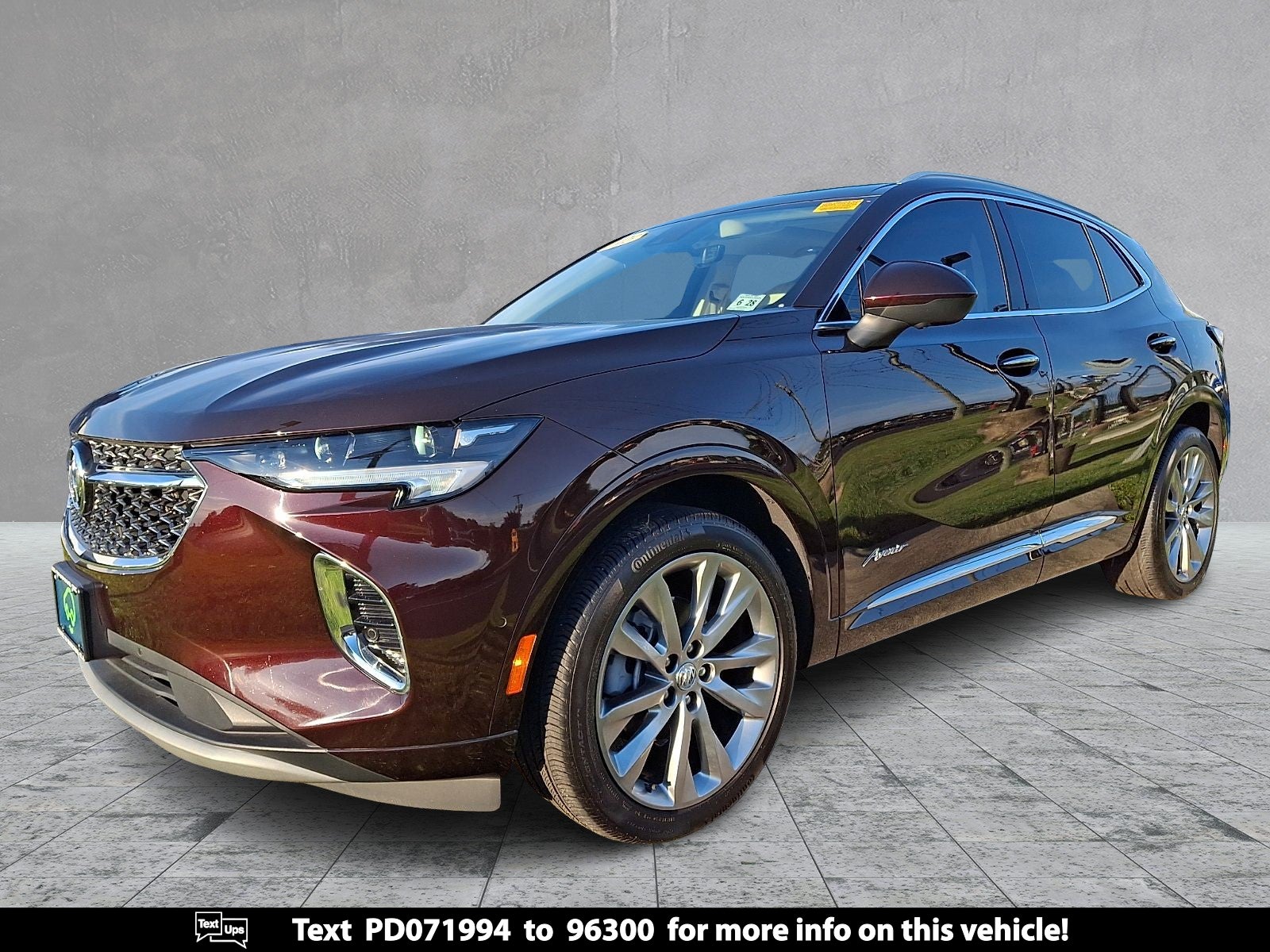 2023 Buick Envision Avenir in Rich Garnet Metallic — front three-quarter view